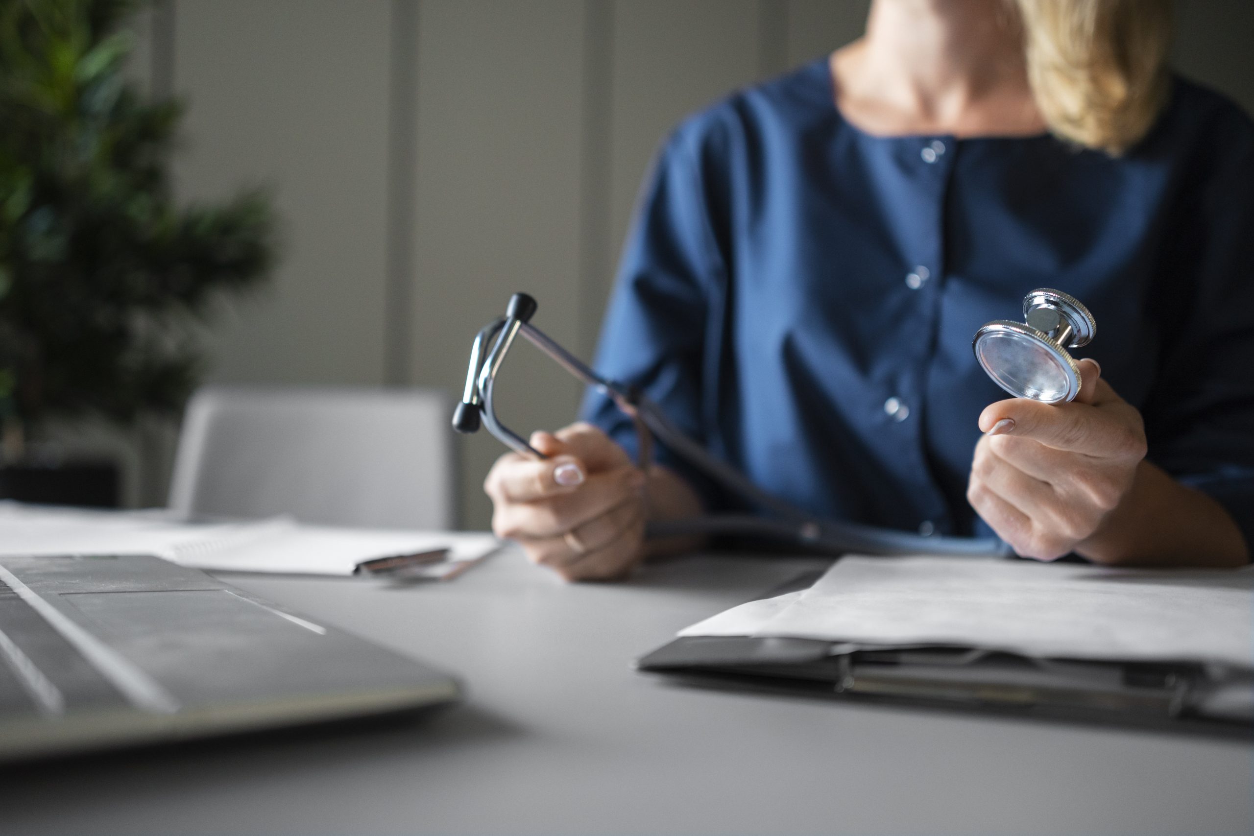 side-view-nurse-holding-stethoscope
